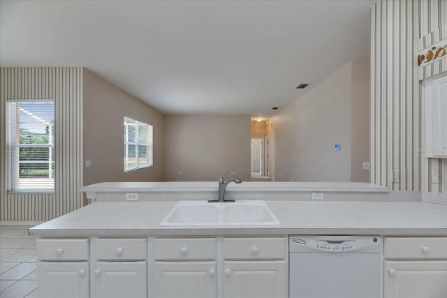 1216 Fox Chapel Dr, Lutz, FL 33549 - kitchen with dishwasher, plenty of natural light, light tile patterned flooring, light countertops, and wallpapered walls