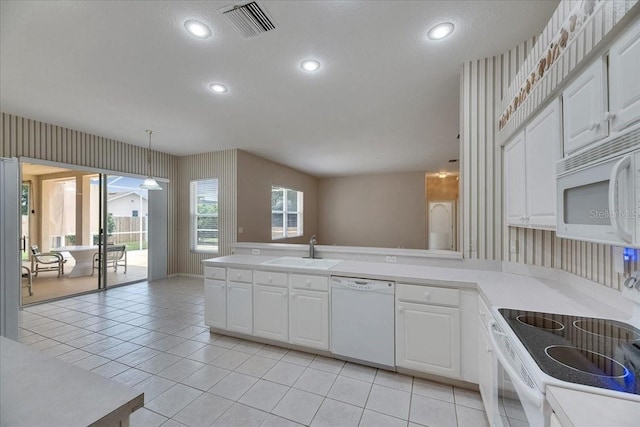 1216 Fox Chapel Dr, Lutz, FL 33549 - kitchen with white appliances, a peninsula, light countertops, white cabinetry, and recessed lighting