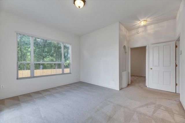 1216 Fox Chapel Dr, Lutz, FL 33549 - unfurnished room featuring light carpet and arched walkways