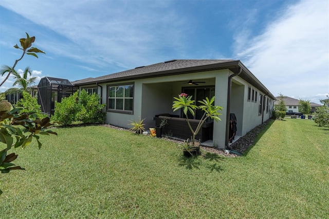 6352 Mooring Line Cir, Apollo Beach, FL 33572 - back of house featuring stucco siding, a lawn, and ceiling fan