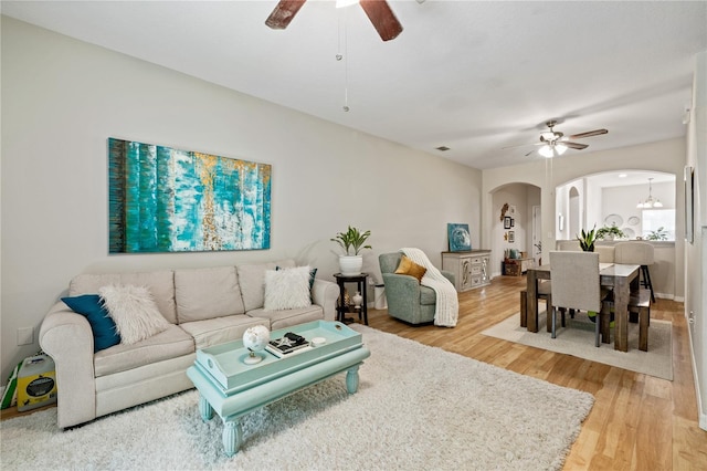 2349 Willimette Dr, Wesley Chapel, FL 33543 - living area featuring arched walkways, ceiling fan, and light wood-style floors