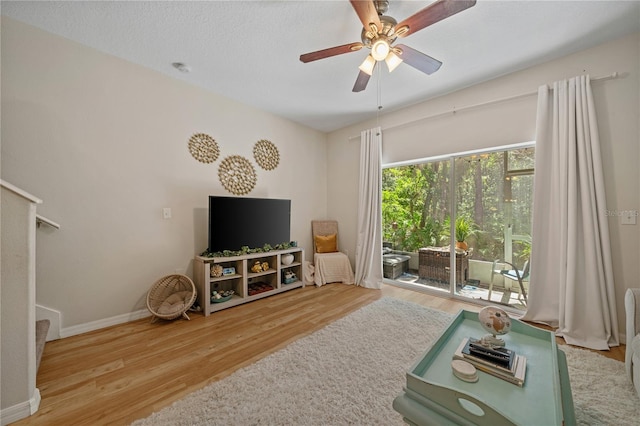 2349 Willimette Dr, Wesley Chapel, FL 33543 - living room featuring wood finished floors, stairway, and a ceiling fan