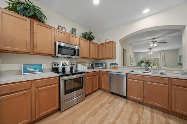 2349 Willimette Dr, Wesley Chapel, FL 33543 - kitchen featuring appliances with stainless steel finishes, light countertops, light wood finished floors, and recessed lighting