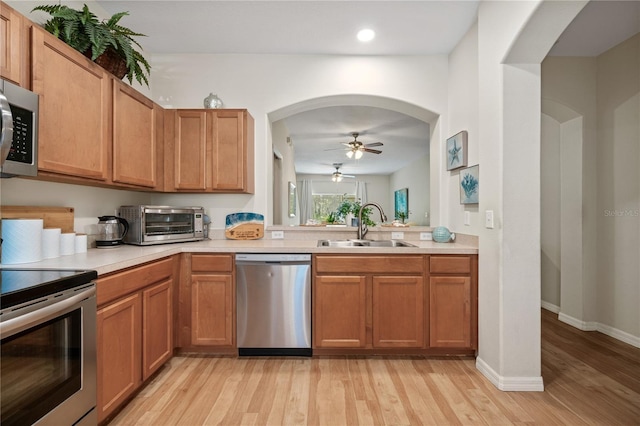 2349 Willimette Dr, Wesley Chapel, FL 33543 - kitchen with appliances with stainless steel finishes, a ceiling fan, light wood finished floors, light countertops, and recessed lighting