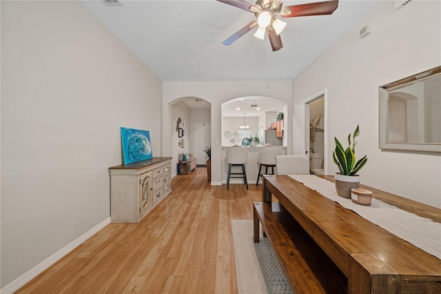 2349 Willimette Dr, Wesley Chapel, FL 33543 - dining area featuring ceiling fan, light wood-style flooring, and arched walkways