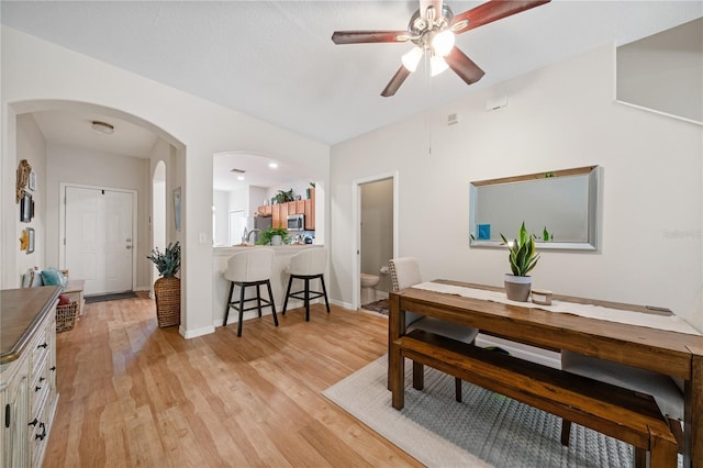2349 Willimette Dr, Wesley Chapel, FL 33543 - dining area featuring light wood-type flooring, arched walkways, and ceiling fan