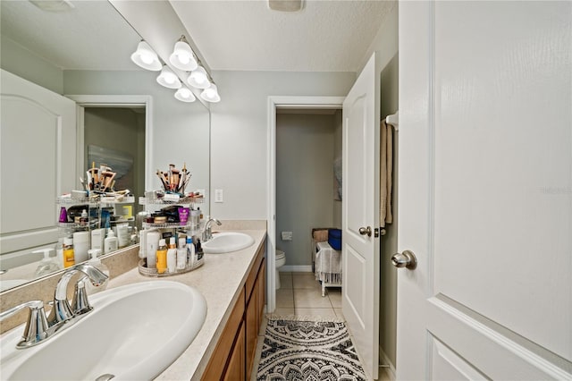 2349 Willimette Dr, Wesley Chapel, FL 33543 - bathroom featuring tile patterned floors, double vanity, and a textured ceiling