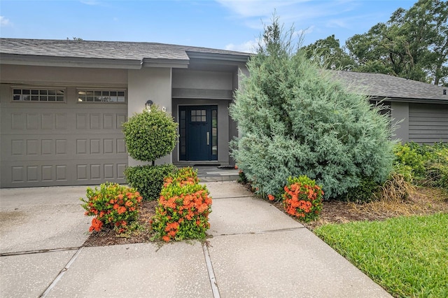 2701 Herndon St, Valrico, FL 33596 - view of exterior entry with a garage and stucco siding