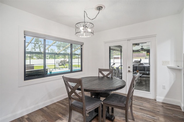 2701 Herndon St, Valrico, FL 33596 - dining area with french doors, plenty of natural light, dark wood-style floors, and a chandelier