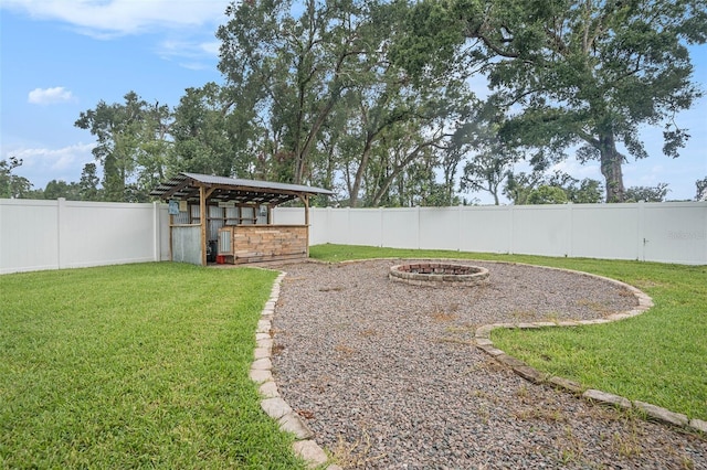 2701 Herndon St, Valrico, FL 33596 - fenced backyard with a fire pit