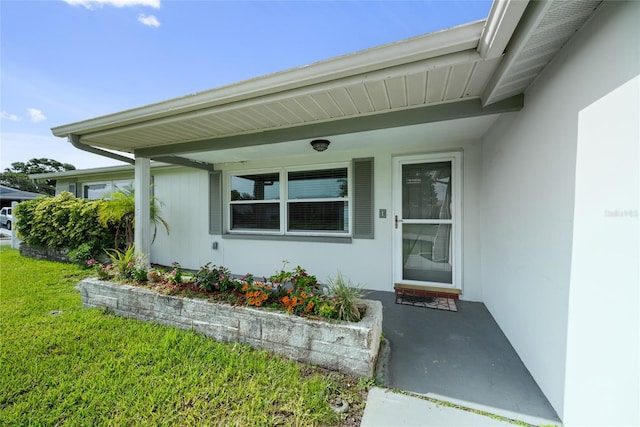 5720 Mockingbird Dr, New Port Richey, FL 34652 - entrance to property featuring stucco siding and a yard