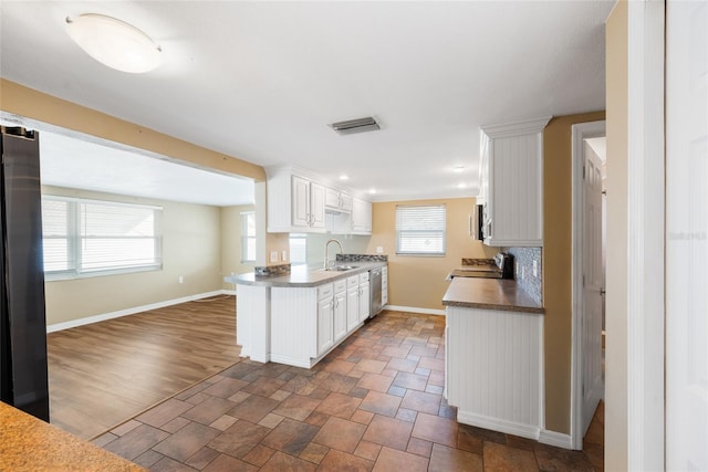5720 Mockingbird Dr, New Port Richey, FL 34652 - kitchen with stainless steel appliances and white cabinets