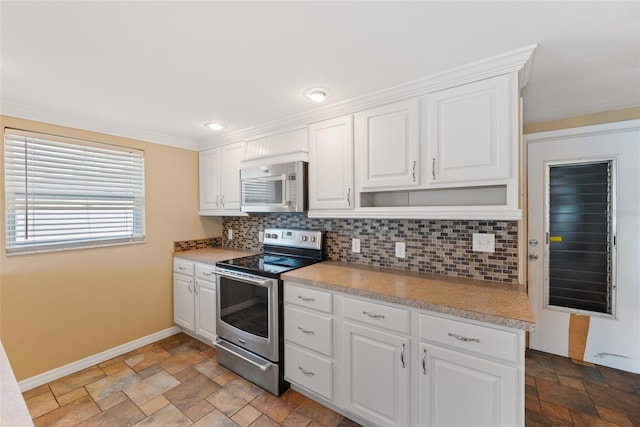 5720 Mockingbird Dr, New Port Richey, FL 34652 - kitchen featuring stainless steel appliances, stone tile flooring, decorative backsplash, and white cabinetry