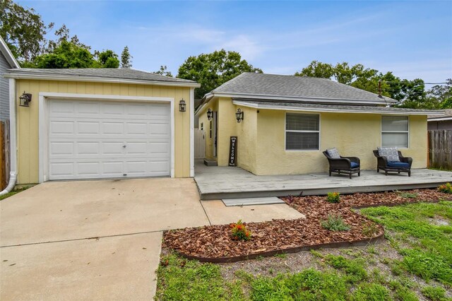 1722 Albemarle Rd, Clearwater, FL 33764 - view of front of property featuring concrete driveway, a wooden deck, a detached garage, and roof with shingles
