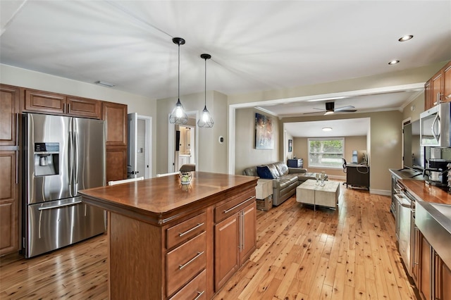 1722 Albemarle Rd, Clearwater, FL 33764 - kitchen with appliances with stainless steel finishes, light wood-style flooring, open floor plan, a kitchen island, and recessed lighting