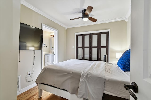 1722 Albemarle Rd, Clearwater, FL 33764 - bedroom featuring ornamental molding, wood finished floors, ensuite bathroom, and a ceiling fan