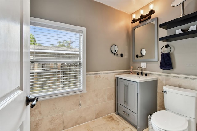 1722 Albemarle Rd, Clearwater, FL 33764 - bathroom with tile walls, vanity, and wainscoting