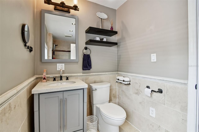 1722 Albemarle Rd, Clearwater, FL 33764 - bathroom with vanity, a wainscoted wall, and tile walls
