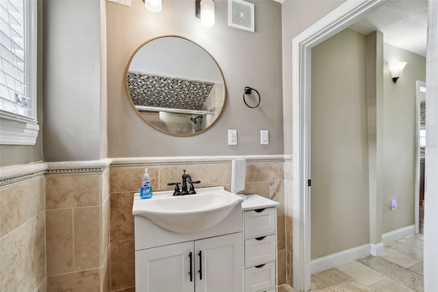 1722 Albemarle Rd, Clearwater, FL 33764 - bathroom with tile walls, vanity, tile patterned flooring, and wainscoting