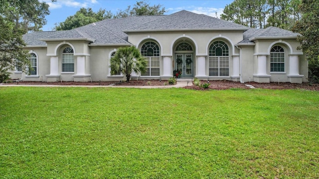 2900 W Lantana Dr, Beverly Hills, FL 34465 - view of front of property with french doors, stucco siding, a shingled roof, and a front lawn