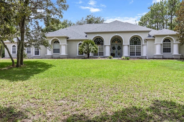 2900 W Lantana Dr, Beverly Hills, FL 34465 - view of front facade featuring french doors, stucco siding, a front yard, and a shingled roof