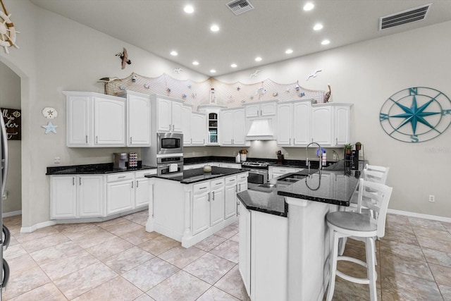 2900 W Lantana Dr, Beverly Hills, FL 34465 - kitchen with appliances with stainless steel finishes, recessed lighting, custom exhaust hood, white cabinetry, and a peninsula