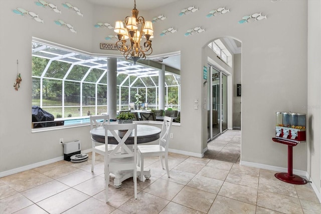 2900 W Lantana Dr, Beverly Hills, FL 34465 - dining space with arched walkways, a sunroom, a high ceiling, a chandelier, and tile patterned flooring