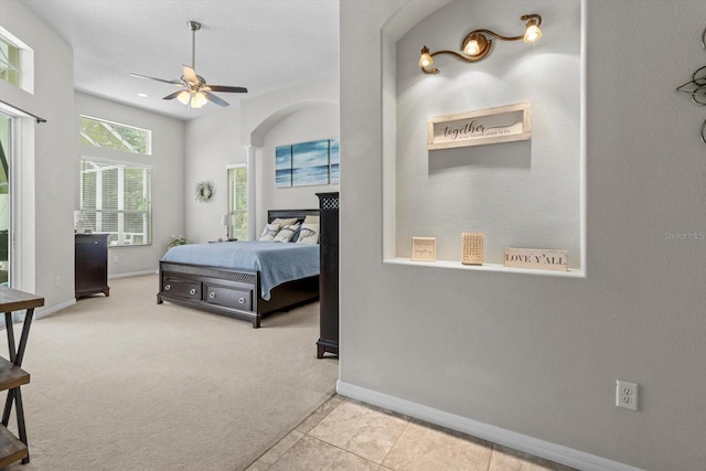 2900 W Lantana Dr, Beverly Hills, FL 34465 - bedroom featuring arched walkways, carpet, a ceiling fan, and tile patterned flooring