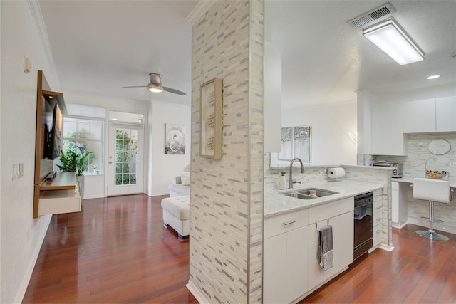 4221 W Spruce St Unit 2328, Tampa, FL 33607 - kitchen featuring black dishwasher, dark wood-type flooring, decorative backsplash, a ceiling fan, and ornamental molding