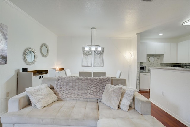 4221 W Spruce St Unit 2328, Tampa, FL 33607 - living room with wood finished floors, ornamental molding, and a chandelier