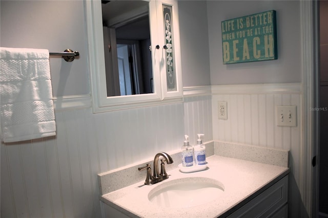 12760 Indian Rocks Rd Unit 909, Largo, FL 33774 - bathroom with vanity and a wainscoted wall
