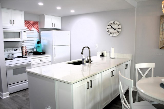 12760 Indian Rocks Rd Unit 909, Largo, FL 33774 - kitchen featuring white appliances, a peninsula, light stone countertops, white cabinetry, and recessed lighting