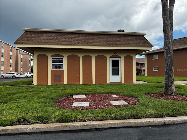 12760 Indian Rocks Rd Unit 909, Largo, FL 33774 - view of front of property featuring mansard roof, a shingled roof, and stucco siding