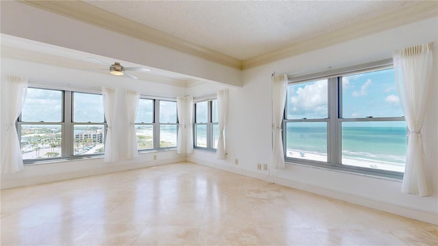 4950 Gulf Blvd Unit 903, St Pete Beach, FL 33706 - spare room with a textured ceiling, healthy amount of natural light, ornamental molding, and ceiling fan