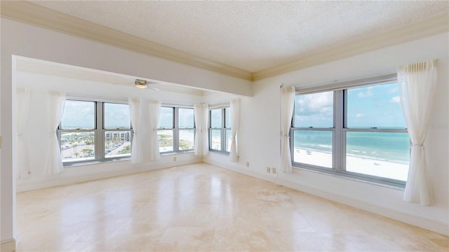 4950 Gulf Blvd Unit 903, St Pete Beach, FL 33706 - spare room featuring a textured ceiling, crown molding, and a ceiling fan