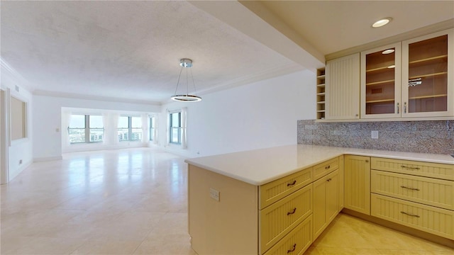4950 Gulf Blvd Unit 903, St Pete Beach, FL 33706 - kitchen with light countertops, backsplash, open floor plan, glass insert cabinets, and recessed lighting