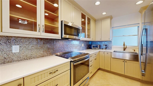 4950 Gulf Blvd Unit 903, St Pete Beach, FL 33706 - kitchen featuring stainless steel appliances, light tile patterned floors, decorative backsplash, light countertops, and recessed lighting