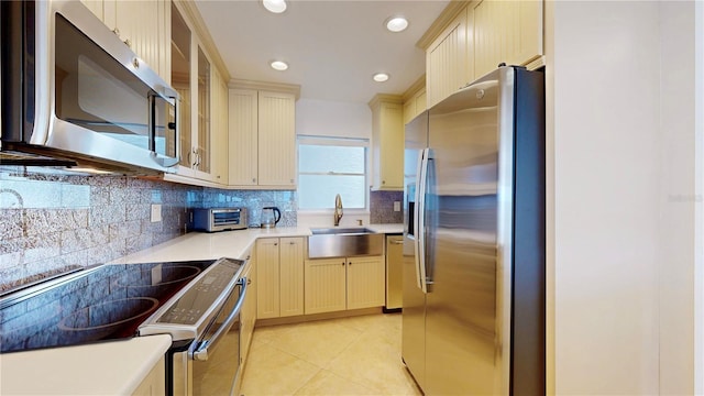 4950 Gulf Blvd Unit 903, St Pete Beach, FL 33706 - kitchen with appliances with stainless steel finishes, backsplash, light tile patterned flooring, light countertops, and recessed lighting
