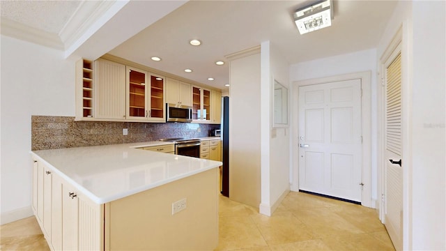 4950 Gulf Blvd Unit 903, St Pete Beach, FL 33706 - kitchen featuring appliances with stainless steel finishes, tasteful backsplash, glass insert cabinets, a peninsula, and light tile patterned flooring