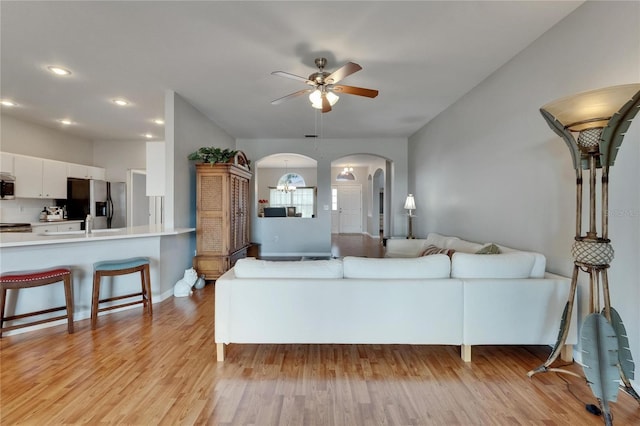 607 Tuscanny St, Brandon, FL 33511 - living area with arched walkways, a ceiling fan, light wood-style floors, and recessed lighting