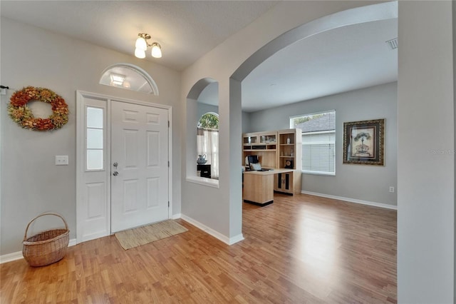 607 Tuscanny St, Brandon, FL 33511 - foyer featuring arched walkways and light wood-style floors