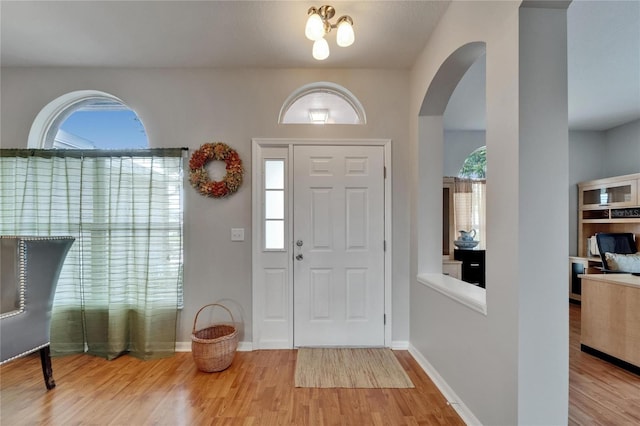607 Tuscanny St, Brandon, FL 33511 - foyer featuring wood finished floors, arched walkways, and plenty of natural light