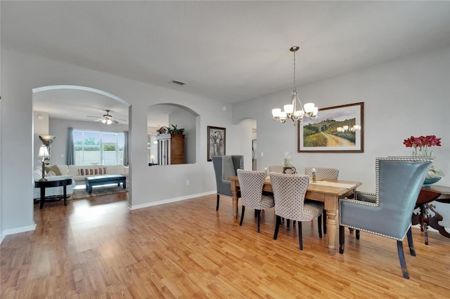 607 Tuscanny St, Brandon, FL 33511 - dining area featuring arched walkways, light wood-style flooring, a chandelier, and ceiling fan