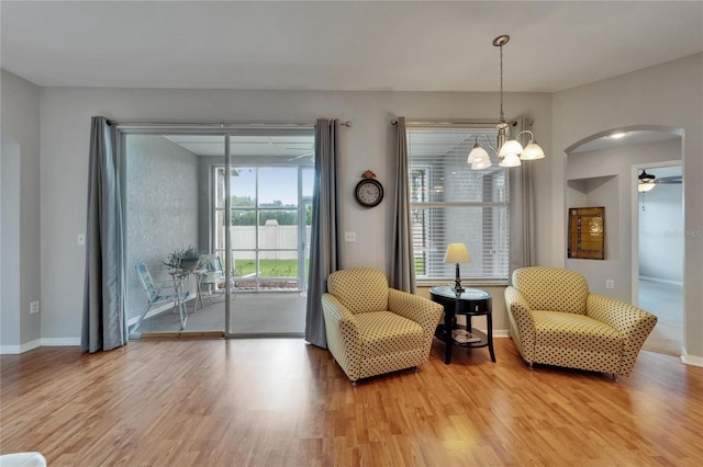 607 Tuscanny St, Brandon, FL 33511 - sitting room with wood finished floors, arched walkways, a chandelier, and ceiling fan