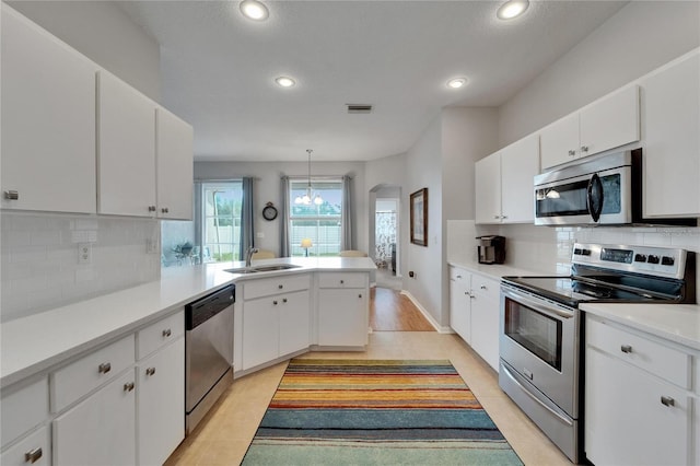 607 Tuscanny St, Brandon, FL 33511 - kitchen featuring appliances with stainless steel finishes, a peninsula, recessed lighting, light countertops, and backsplash