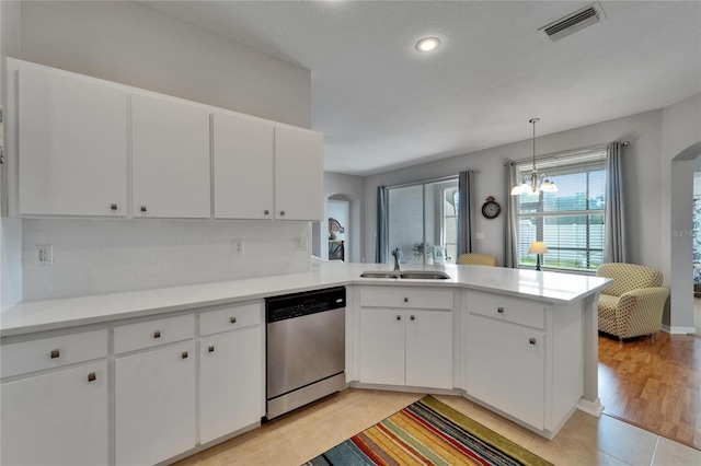 607 Tuscanny St, Brandon, FL 33511 - kitchen featuring stainless steel dishwasher, arched walkways, a peninsula, backsplash, and light countertops