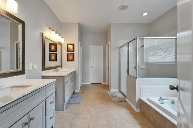 607 Tuscanny St, Brandon, FL 33511 - full bathroom featuring two vanities, a stall shower, a bath, and tile patterned floors