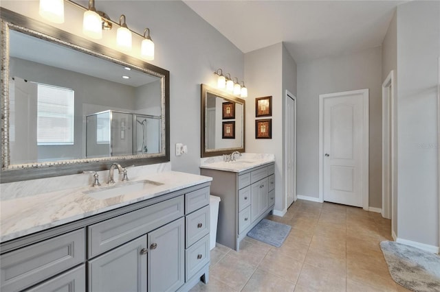 607 Tuscanny St, Brandon, FL 33511 - full bathroom featuring two vanities, a stall shower, and tile patterned flooring