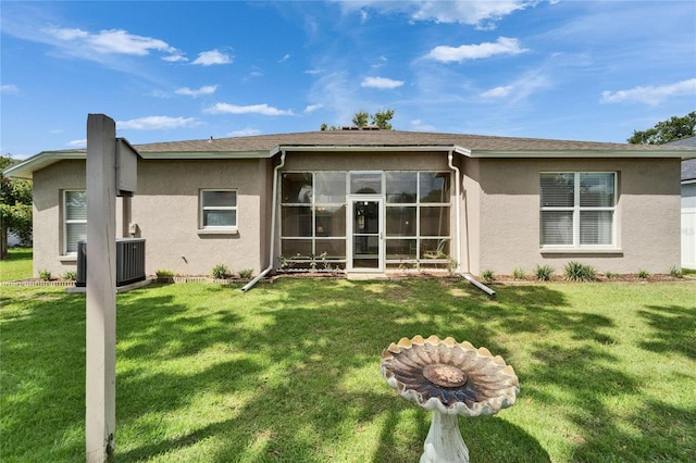 607 Tuscanny St, Brandon, FL 33511 - rear view of house featuring stucco siding, a yard, and a sunroom