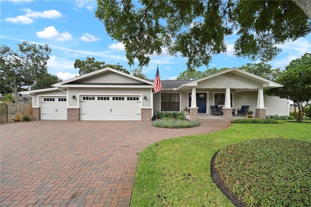 22238 River Rock Dr, Land O Lakes, FL 34639 - craftsman-style house featuring brick siding, an attached garage, decorative driveway, and a porch